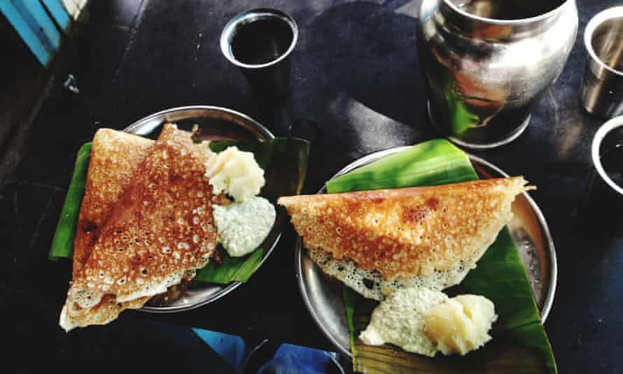 Dosa with coconut sauce and mashed potato on banana leaves