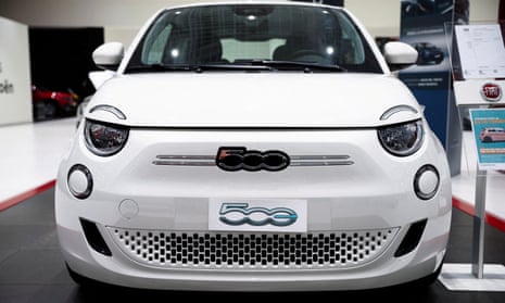 A white Fiat 500 electric car is displayed at a showroom of a car dealer in Rome