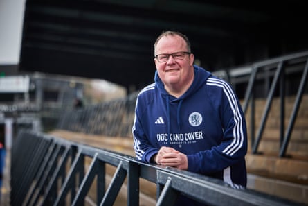 Bob Trafford smiles as he leans against a railing in the stadium’s stands