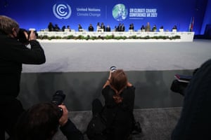 Members of the press photograph speakers on stage during the Cop26 opening ceremony