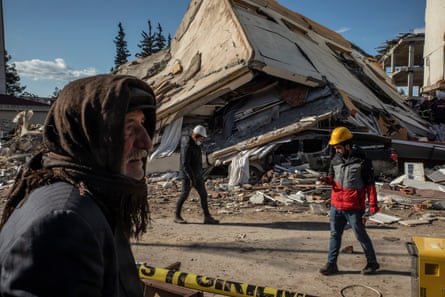 Man in Pazarcık looks over rubble