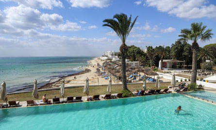 A tourist swims in a pool at a hotel in Tunisia