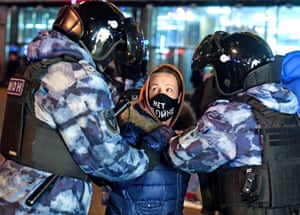 Police officers detain a protester in Moscow’s Pushkin Square on Thursday night.