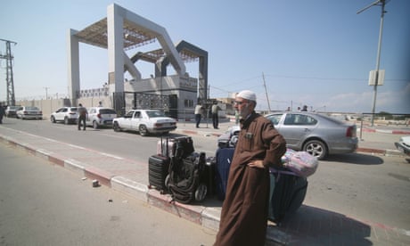 A Palestinian man waits at the Rafah border crossing between the Gaza Strip and Egypt