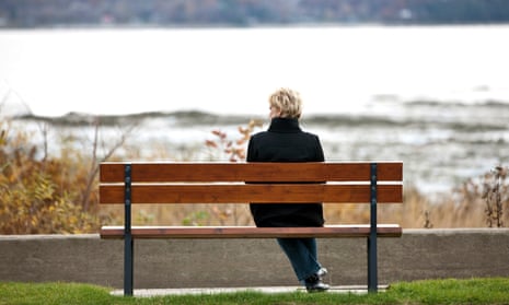 Woman sitting alone on park bench.
