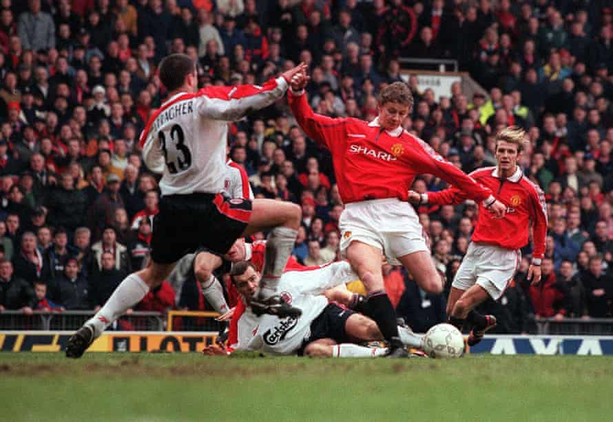 Ole Gunnar Solskjær shoots past Jamie Carragher for the winner in injury time in the FA Cup fourth round in January 1999