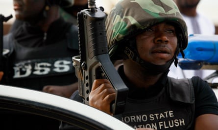 The Borno state task force, Operation Flush, stands guard during a religious celebration in Maiduguri, in 2013.