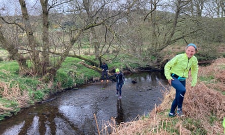 Runners crossing a highland stream