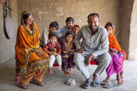Maula Dinno with his wife, Nusrat, and their children, at their home in Sindh.