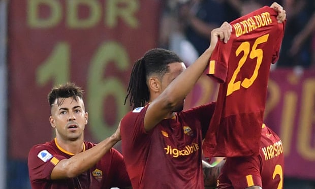 Chris Smalling holds up a shirt bearing Georginio Wijnaldum’s name and number, after the Dutchman fractured his tibia on Sunday.