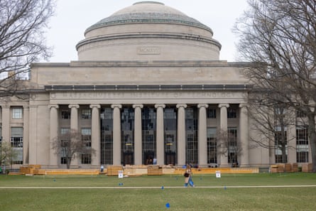 two people walk past the outside of the Great Dome at Massachusetts Institute of Technology