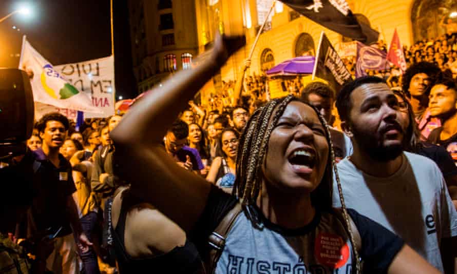 A woman shouts slogans during a protest against the Brazilian government following the fire.