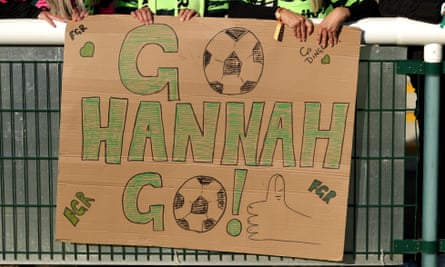 Forest Green Rovers fans hold up a cardboard 'Go Hannah Go!'  banners