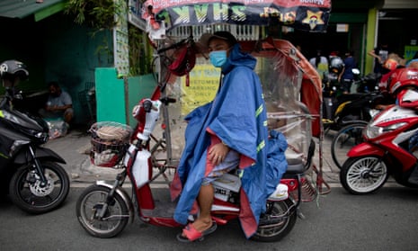A rickshaw driver wears a makeshift protective Covid-19 suit and mask as he waits for passengers in Manila, Philippines.