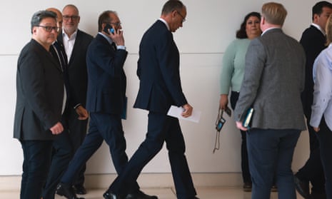 Chairman of the Christian Democratic Union (CDU) party and faction Friedrich Merz and Christian Social Union (CSU) regional group chairman in the German parliament Bundestag Alexander Dobrindt (C-L) leave Merz's office after talks.