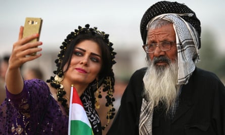 An Iranian Kurdish woman takes a selfie with a man at a gathering near Erbil to urge people to vote in the referendum.