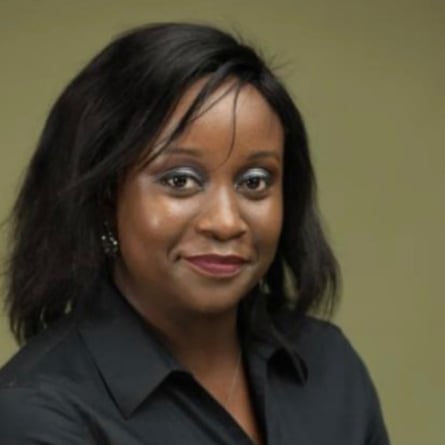 A middle-aged African woman in a dark shirt