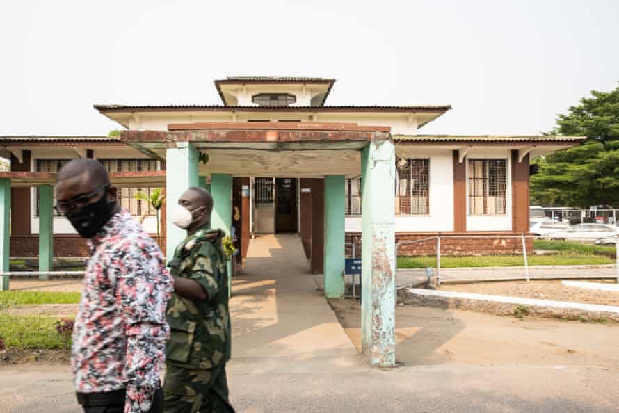 two men walk past Clinique Ngaliema in Kinshasa.