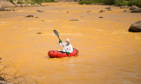 Nathan Shoutis paddles the discolored Animus river in Durango, Colorado, shortly after an EPA remediation project resulted in the breach of millions of gallons of toxic mining waste