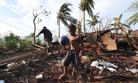 A boy walks through through the ruins of his family home in Port Vila, Vanuatu after Cyclone Pam devastated the town in 2015. The country has co-sponsored a resolution on climate obligations at the UN.