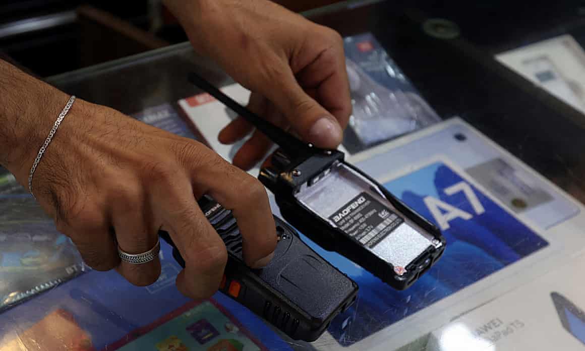 A vendor shows a walkie-talkie device.
