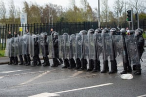 Police carrying riot shields