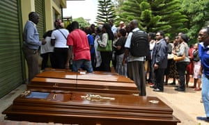 Relatives stand next to empty coffins at the Chiromo mortuary in Nairobi, Kenya, on Wednesday.