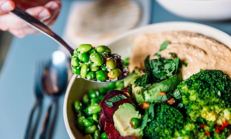 A bowl of edamame beans, broccoli and humous