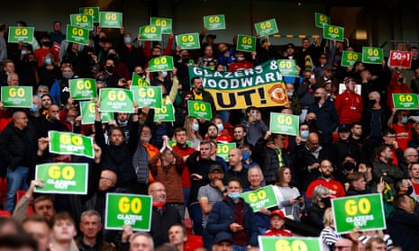 Manchester United fans hold up banners protesting against the Glazer ownership of Manchester United.