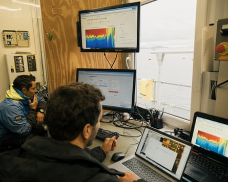 Two men working on computers in an office.