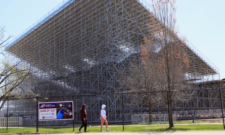 Pedestrians walk past the Nassau County International Cricket Stadium