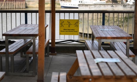 A social distancing sign at an outside restaurant in London.