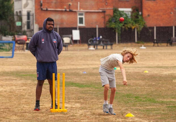 Sachithra Serasinghe supervises bowling practice at the summer cricket camp.