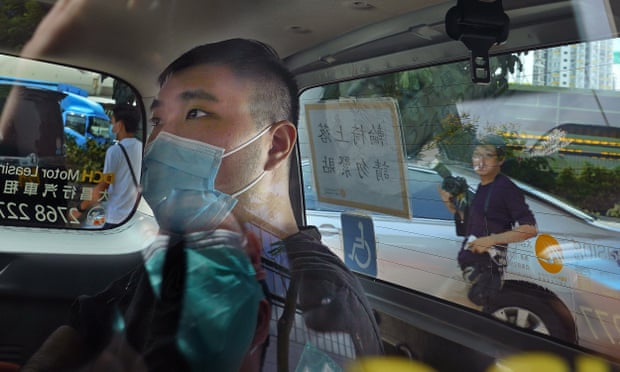 Tong Ying-kit arrives at court in a police van in July last year