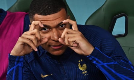 Kylian Mbappé of France makes a camera gesture back at a photographer during the match against Tunisia.