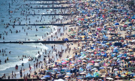 Thousands of  visitors crowd together on Bournemouth beach on June 25.