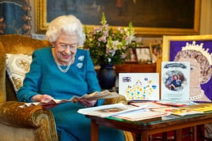 2022: Queen Elizabeth II looking at Queen Victoria’s Autograph fan, alongside a display of memorabilia from her Golden and Platinum Jubilees, in the Oak Room at Windsor Castle, in January ahead of the Platinum Jubilee