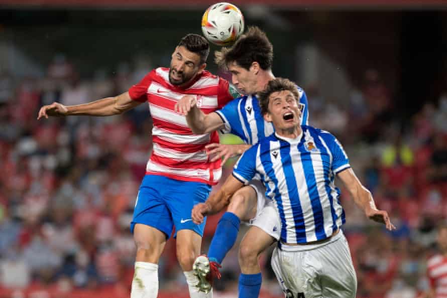 Real Sociedad defenders Aritz Elustondo (centre) and Robin Le Normand (right) go up for a header.