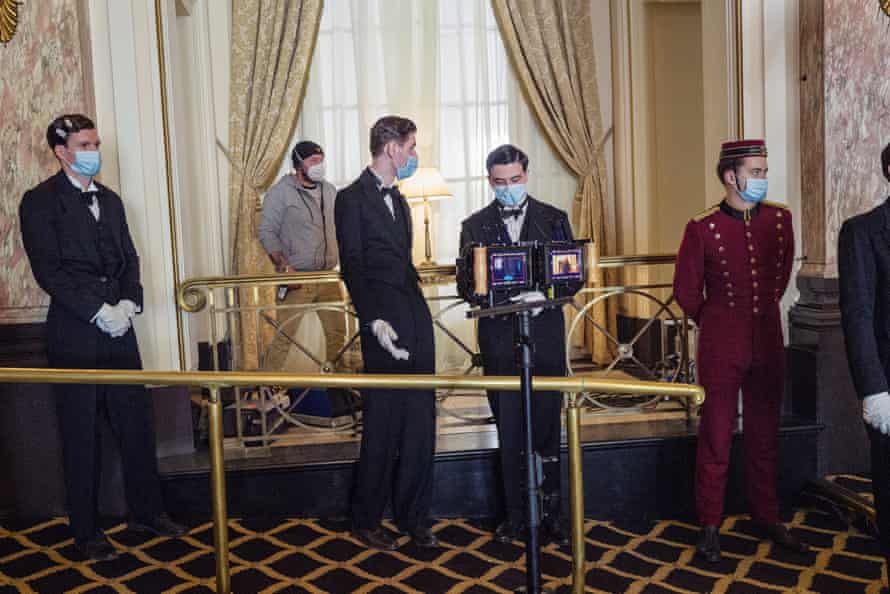 Extras waiting for an elaborate dining scene to start