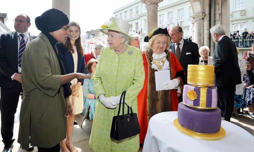 Britain’s Queen Elizabeth greets Nadiya Hussain, winner of the Great British Bake Off who baked a cake for her as she walks through Windsor on her 90th Birthday, in Windsor, Britain April 21, 2016. REUTERS/John Stillwell/Pool