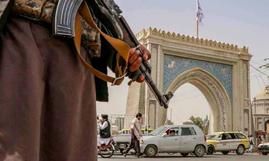 A Taliban fighter stands guard at a checkpoint in Kandahar, Afghanistan, on Tuesday.