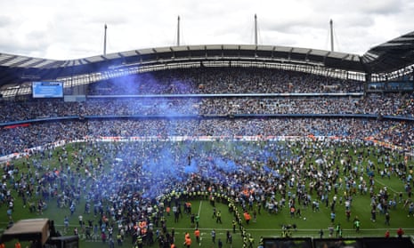 Supporters run on to the pitch at the final whistle after Manchester City had secured the Premier League title with victory over Aston Villa.