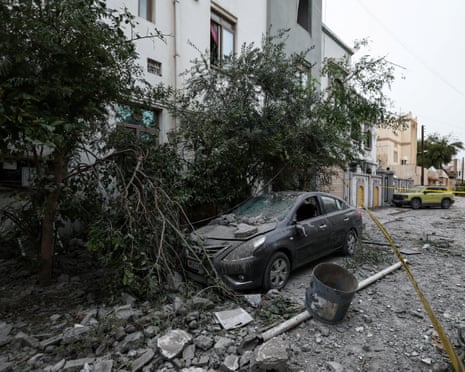 A wrecked car near damaged buildings at the site of what Bahrain said was falling debris of an intercepted Iranian drone at the weekend