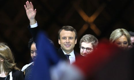 Emmanuel Macron arrives on stage at the Louvre after winning Sunday’s presidential election