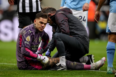 Goalkeeper Ederson of Manchester City is treated by a physio