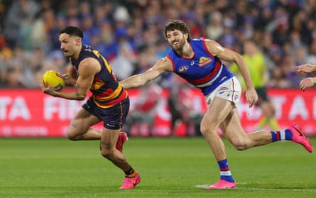 Izak Rankine runs away from Marcus Bontempelli as Adelaide host Western Bulldogs in an AFL elimination final