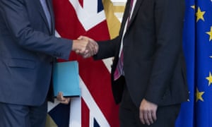 Two men shaking hands with uk and eu flags in background