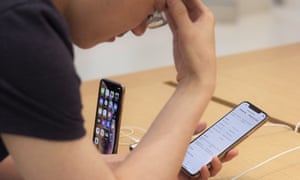 A customer looks at the new iPhone XS Max at an Apple store in New York. There are reports that some of the devices suffer from an issue with charging.