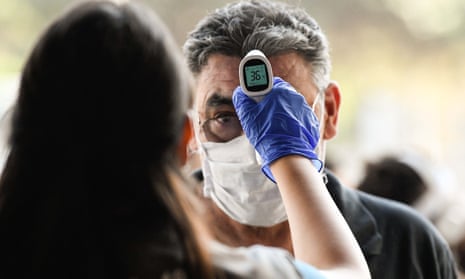 A man gets his temperature checked at a bus station amid the Covid-19 pandemic in Santiago, Chile, which has proposed issuing ‘immunity passports’ – a practice the WHO warned today could be dangerous.