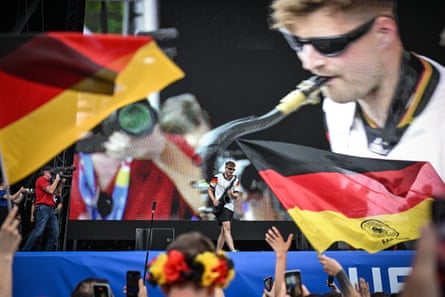 German saxophonist Andre Schnura performs for on stage at the Westfalenpark fan zone in Dortmund ahead of German’s round of 16 match against Denmark.
